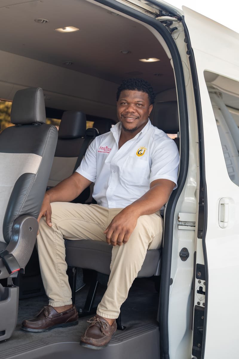 AATA driver standing proudly by shuttle van